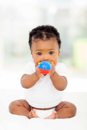 22138863 - cute african baby girl biting her toy